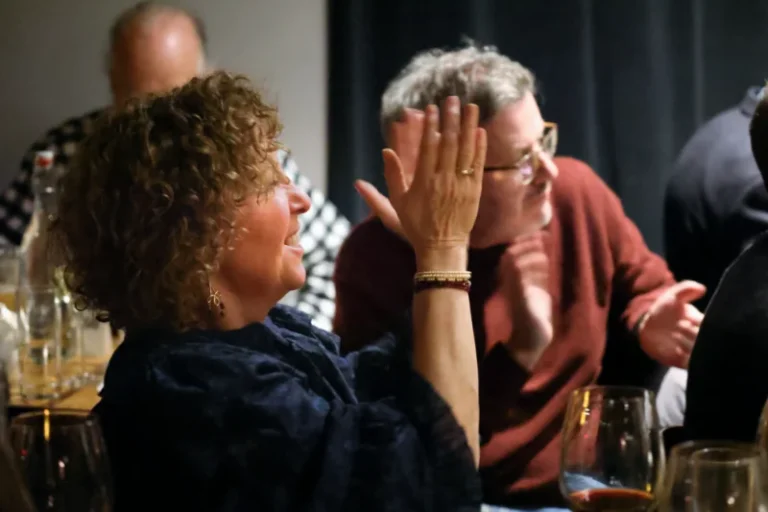 Woman clapping in the audience at the Jazz Forum